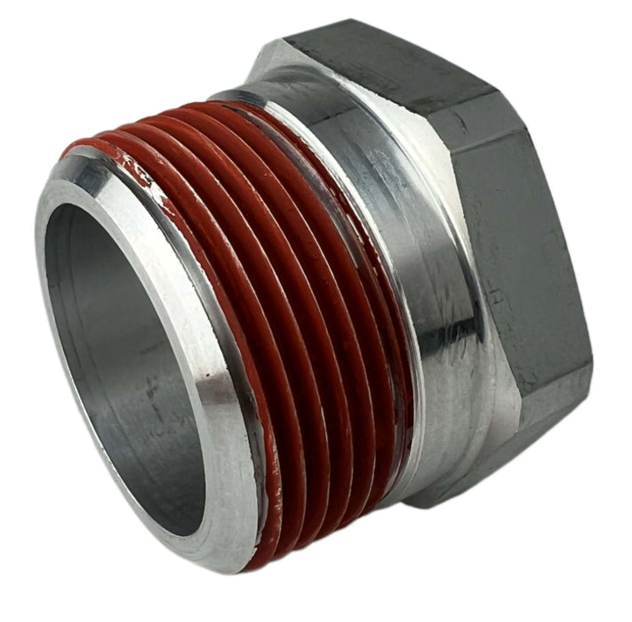 A silver thermal relief plug with red thread sealant on the threads