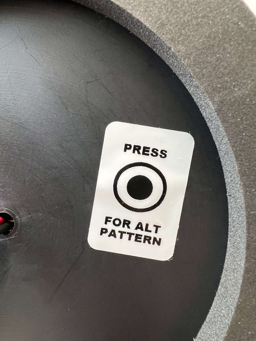 A close view of the bottom of 799A beacon light with a sticker showing "Press For Alt Pattern"
