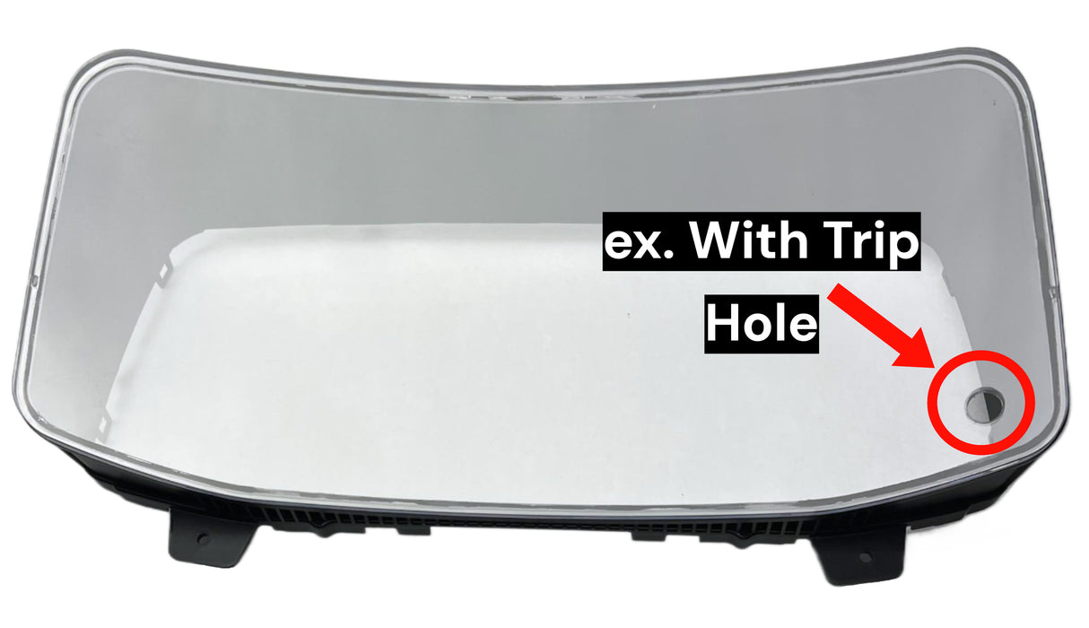 DD60026 - A diagram of a international intrument cluster cover fram with an arrow pointing at a hole saying "With Trip Hole" on a white background